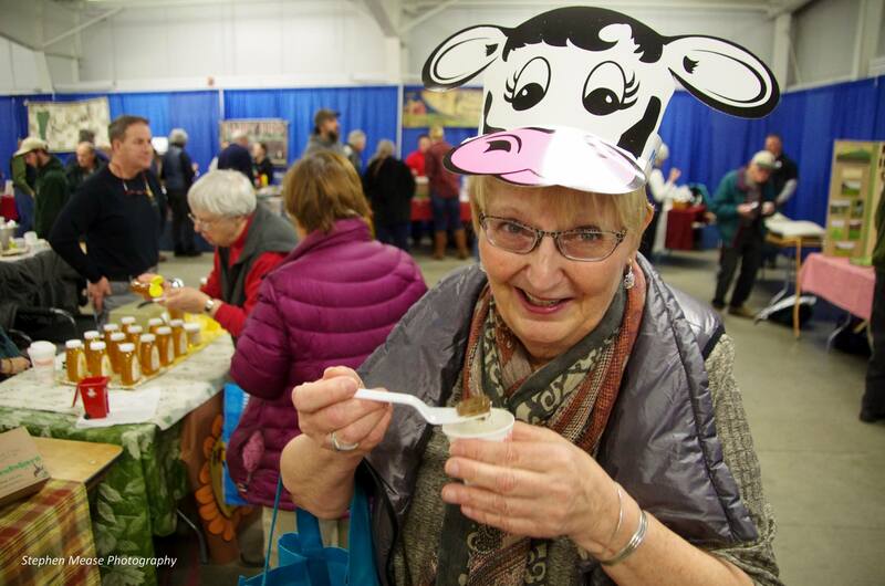 VT Farm Show attendee with cow hat and eating a treat