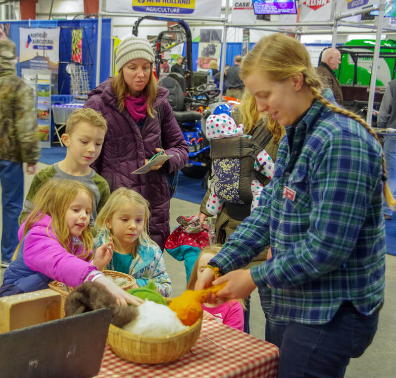VT Farm Show vendor interacting with children 